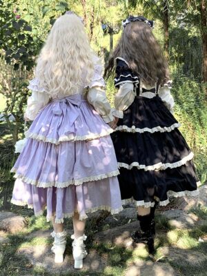Gothic fairy lolita dress back view showing large waist bow and layered ruffled skirt with contrast beige puff sleeves