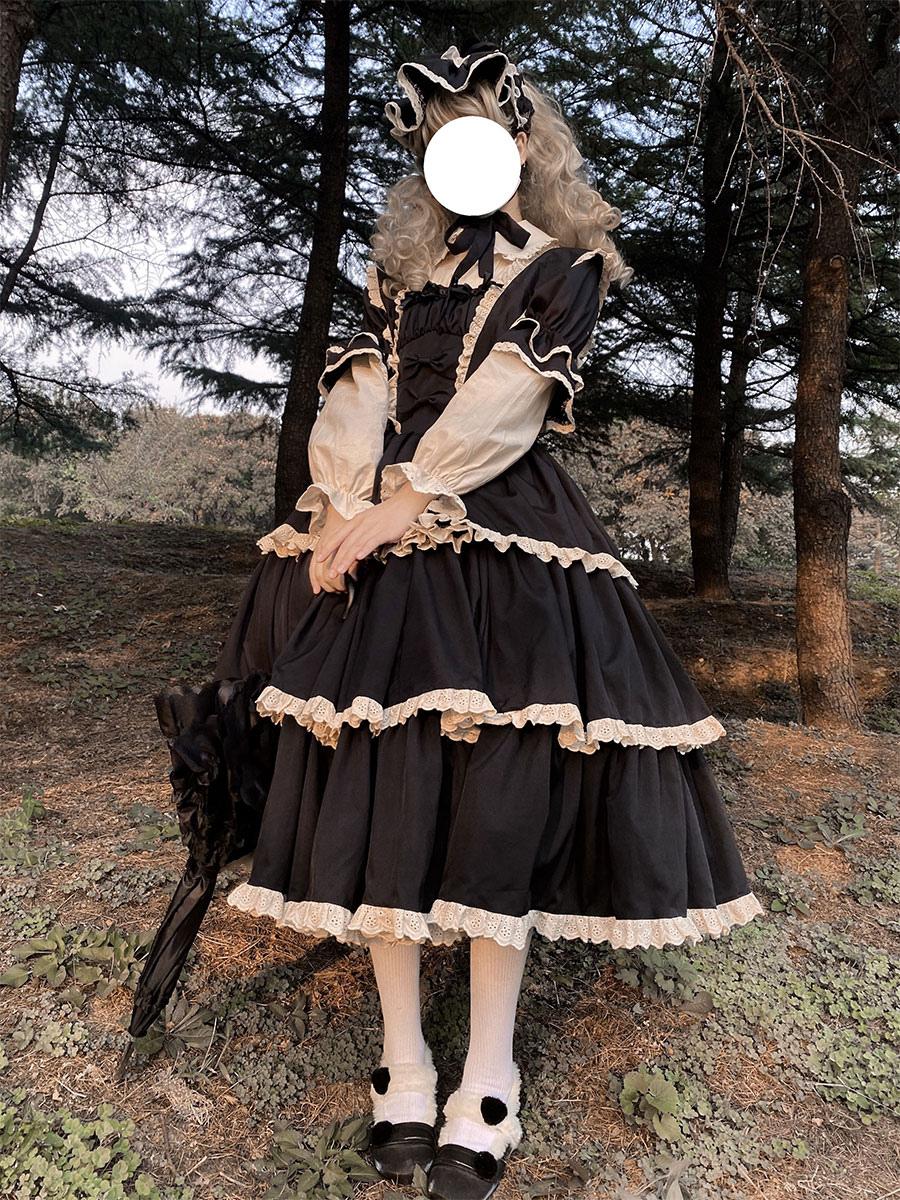 Black gothic lolita dress three-quarter front view with contrast beige puff sleeves lace neckline and white umbrella accessory