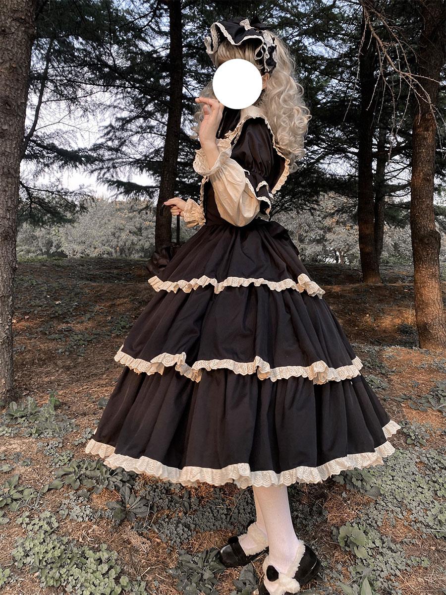 Black gothic lolita dress side back view with tiered ruffled skirt puffed long sleeves and model lifting skirt detail shot