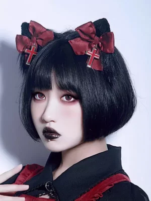 gothic lolita cat ear hair clips with cross bow charm front three-quarter view on model with short black bob hair and gothic makeup