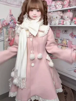 Pink sweet lolita winter overcoat with white pom-pom trim and fringe scarf modeled by twin-tailed girl in studio setting showing front full body view and lace hem details