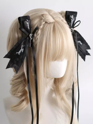gothic lolita bow hair clips with script print side view showing black bows rhinestone accents and flowing tassels on blonde mannequin twin buns