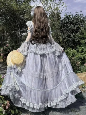 Rear full view of blue fairy lolita dress displaying sheer puff sleeves, ruffled lace hemline, and multi-layered tulle construction with accessories