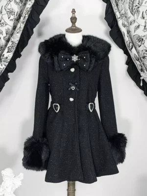Black sweet lolita wool blend winter coat with faux fur collar and cuffs displayed on mannequin, featuring A-line silhouette, heart-shaped waist buckles, and bow snowflake front brooch against vintage curtain backdrop