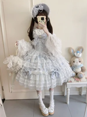 Light sky blue sweet lolita sleeveless jumper dress with tiered lace ruffles and pearl trims worn in mirror selfie showing full-length silhouette