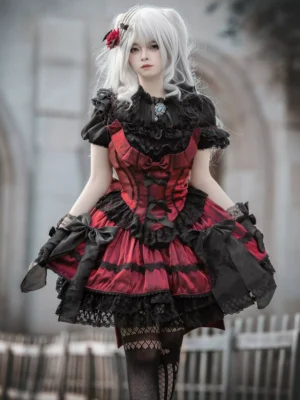Gothic Lolita sleeveless jumper dress front view white-haired model outdoor church setting red black color block ruffled lace bows