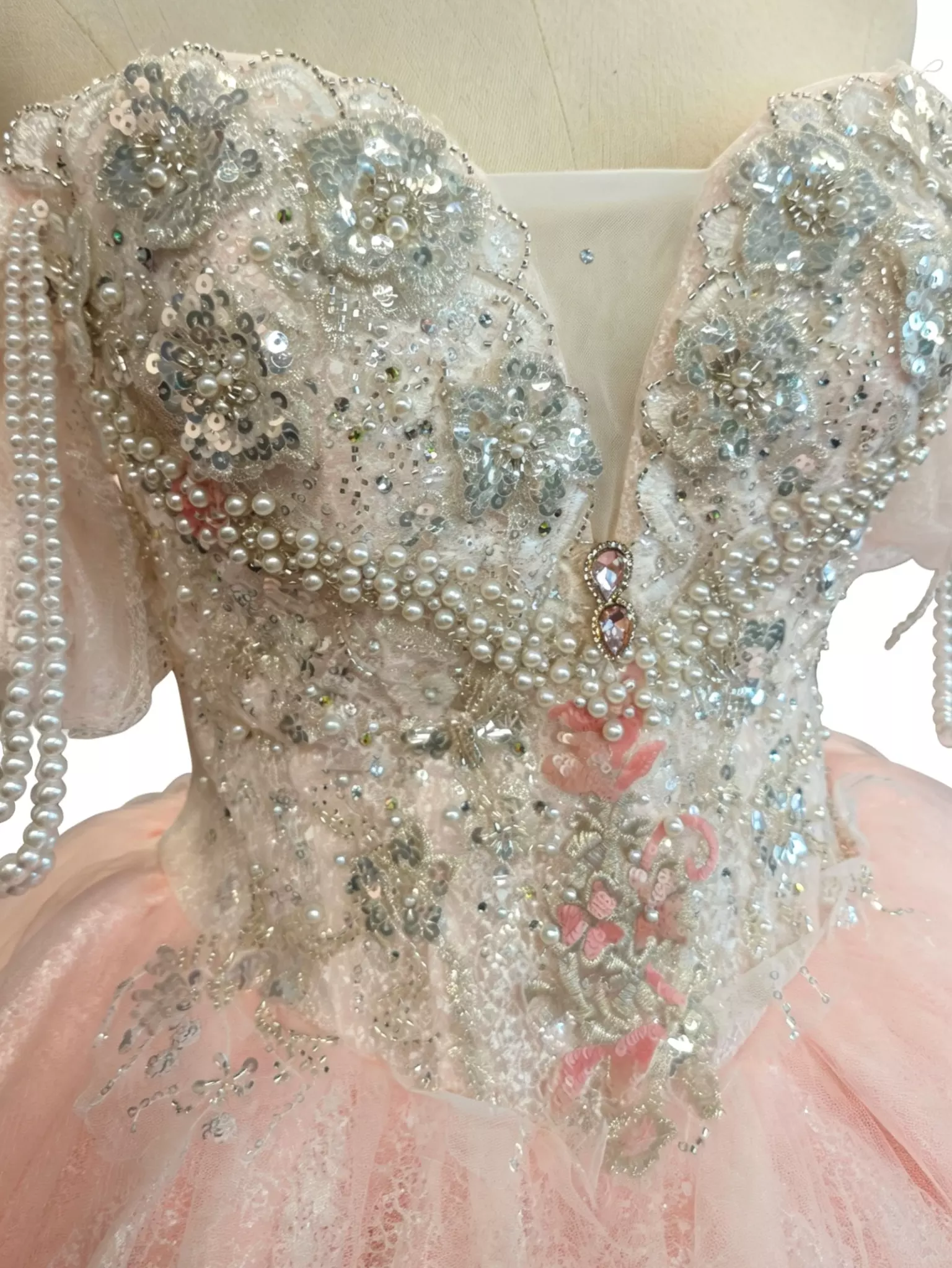 Sweet lolita dress silver crystal beaded bodice large embroidery pink floral accents pearl strands luxury embellishment close-up