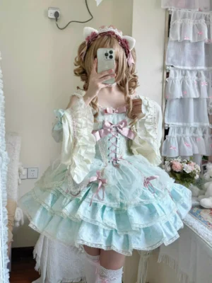 Mint green sweet Lolita dress with pink bows lace-up bodice full front view on model wearing matching detachable lace sleeves and cat ear headband