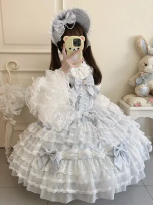 Half-body mirror shot of light sky blue lolita dress featuring sheer lace flare sleeves and decorative bow trims on bodice