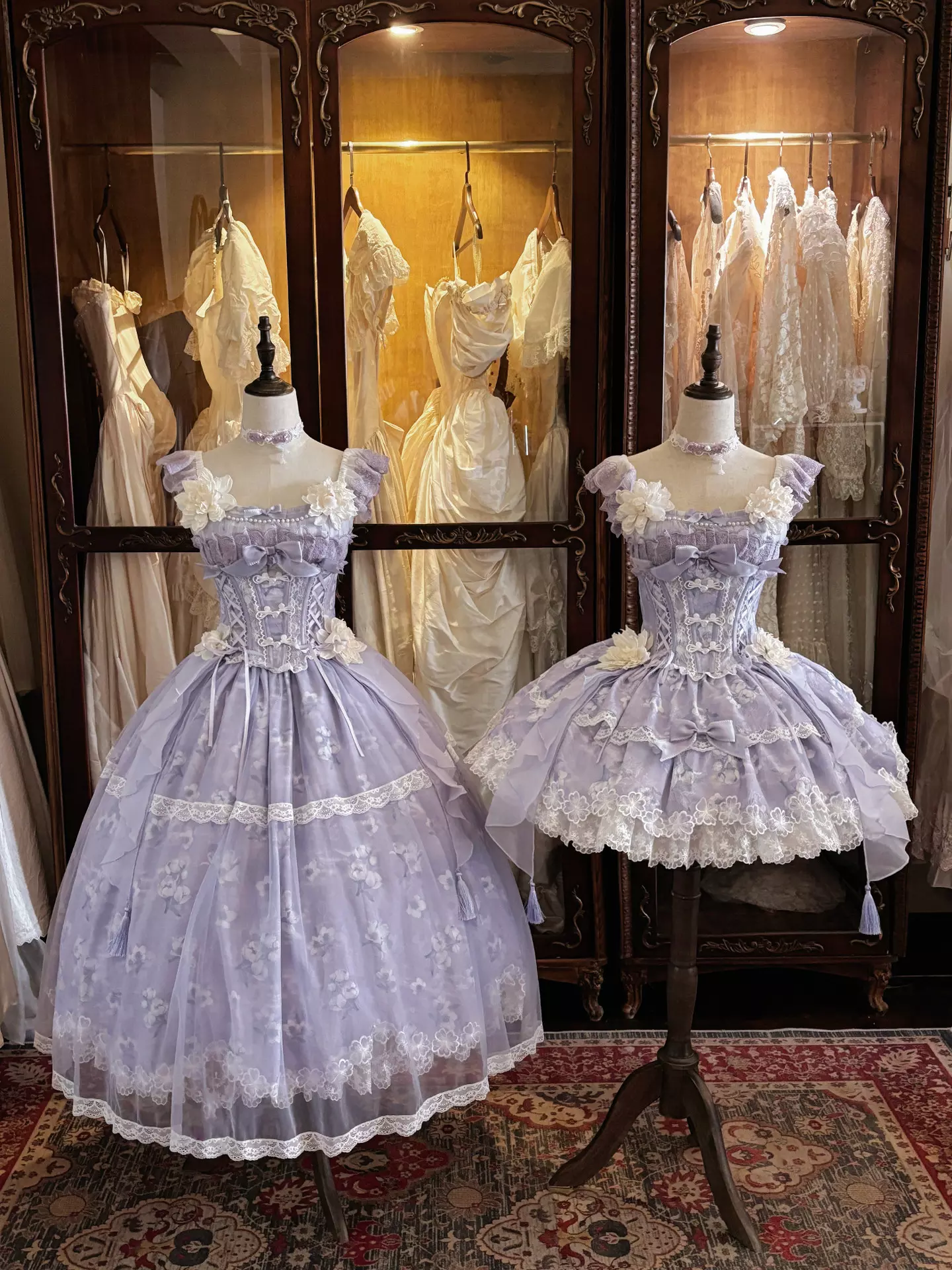 Two purple lolita dresses displayed together showing mini and full-length versions with matching floral lace style and ruffled design