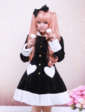 Black wool lolita overcoat front view with fuzzy white trims, heart-shaped pockets, and pom-pom details worn by model with pink twin tails