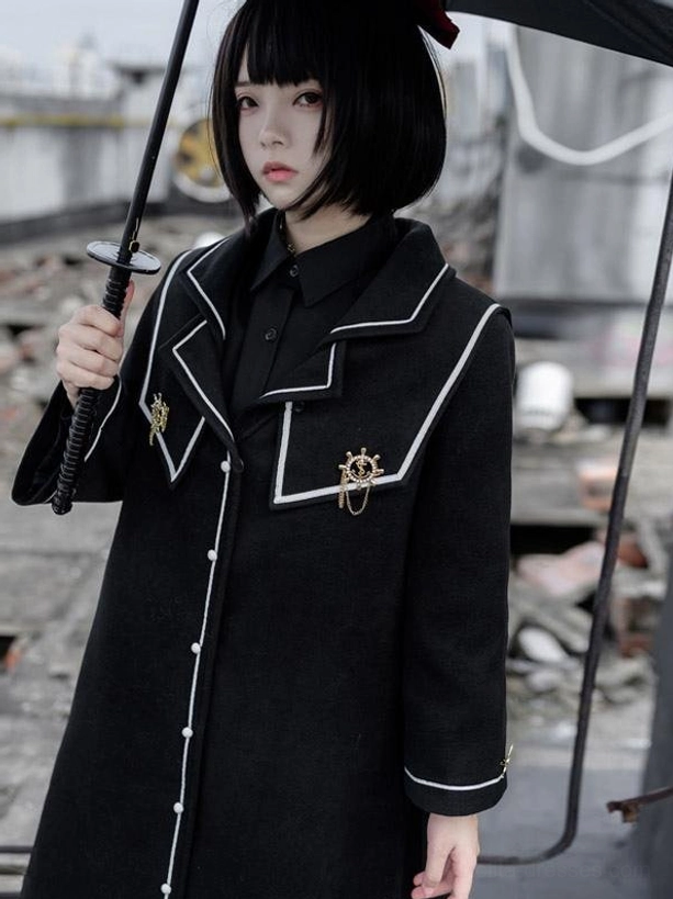 Black academic lolita coat close-up detail of pearl buttons white trim collar emblems and metal badges on polyester long sleeve overcoat