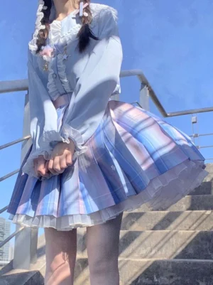 Academic lolita blue ombre pleated skirt with ruffled blouse and matching bow outdoor stairway setting