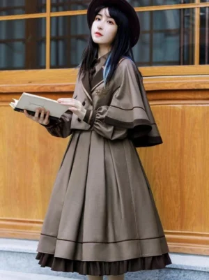 Academic lolita coffee brown cape winter suit styled on model with pleated skirt bishop sleeves fedora outdoor vintage aesthetic