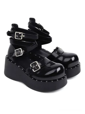 Black patent leather academic lolita platform shoes with multiple silver buckle straps and round toe front three-quarter view showcasing studded platform sole
