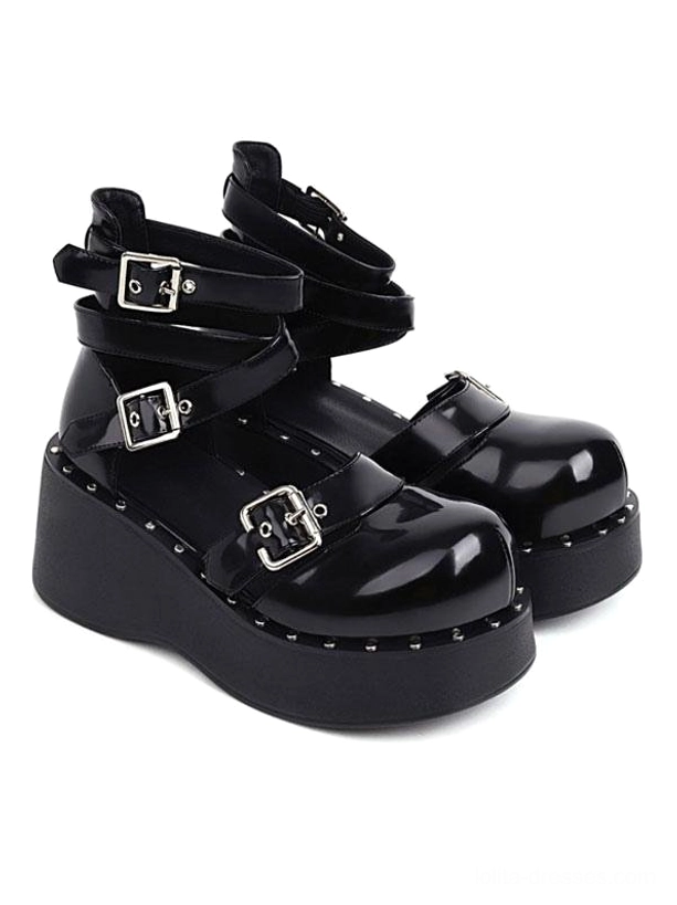 Black patent leather academic lolita platform shoes with multiple silver buckle straps and round toe front three-quarter view showcasing studded platform sole