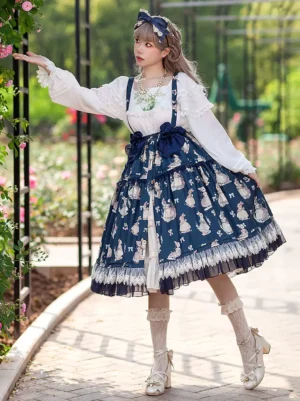 Apricot bunny print lolita suspender skirt three-quarter front view showing layered lace hem and waist satin bow on female model in rose garden outdoor setting