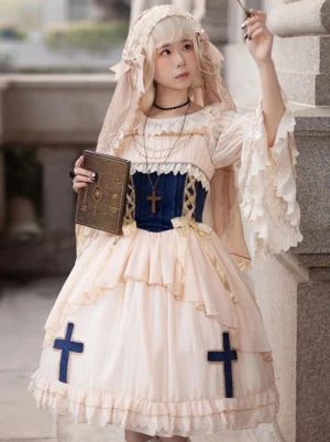 Apricot gothic lolita dress with cross embroidery front view on model wearing nun veil and pearl necklace outdoor stone architecture