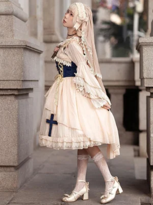 Apricot gothic lolita dress side rear angle showing lace sleeves flare and cross decoration on chiffon skirt with knee-high heels