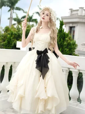 Apricot Hime sweet lolita jumper dress front three-quarter view with black waist bow and tiered ruffled skirt on model wearing floral headpiece