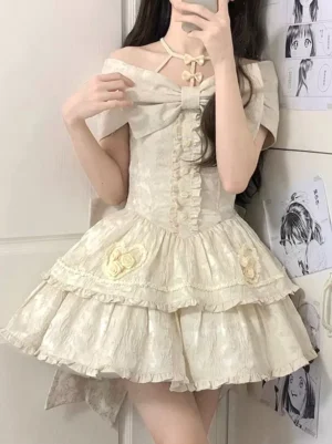 Apricot sweet Lolita jumper skirt front view with 3D flower embellishments, oversized front bow, and ruffled skirt design worn by model in mirror selfie pose