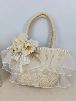 Apricot sweet lolita straw handbag front three-quarter view showing layered tulle ruffles pearl trim artificial peony flowers lace bow embellishment