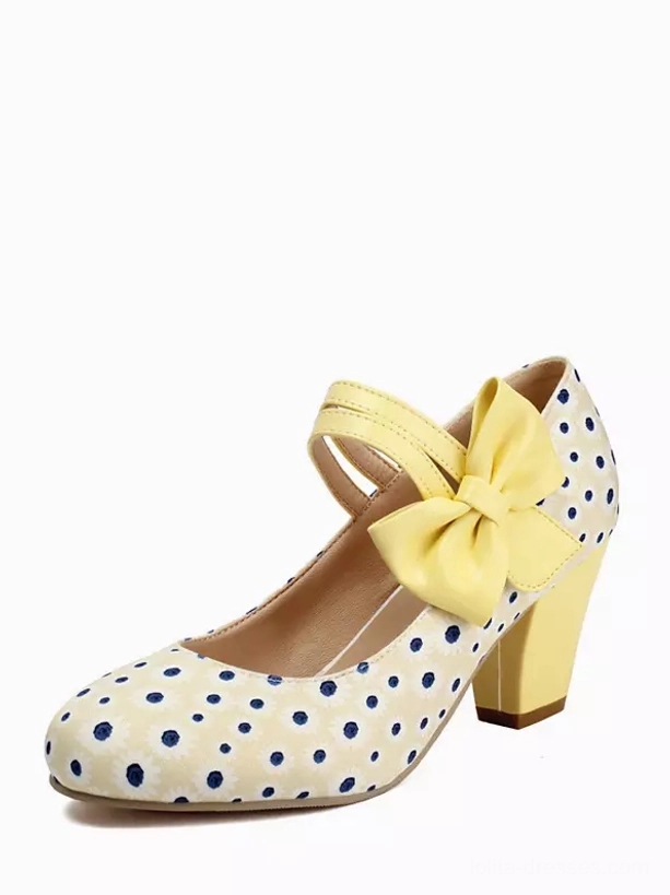 Beige polka dot Mary Jane lolita pumps with yellow bow strap, round toe, and chunky block heel - front three-quarter studio view