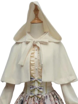 Beige lolita hooded cape cloak front flat lay display with dress form wearing coordinated sweet lolita outfit, showing delicate neck bow detail and soft matte synthetic fabric texture