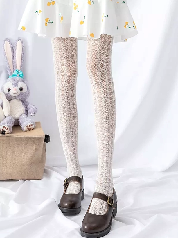 Beige diamond mesh lolita tights front low-angle view with yellow cherry print skirt and brown mary jane shoes
