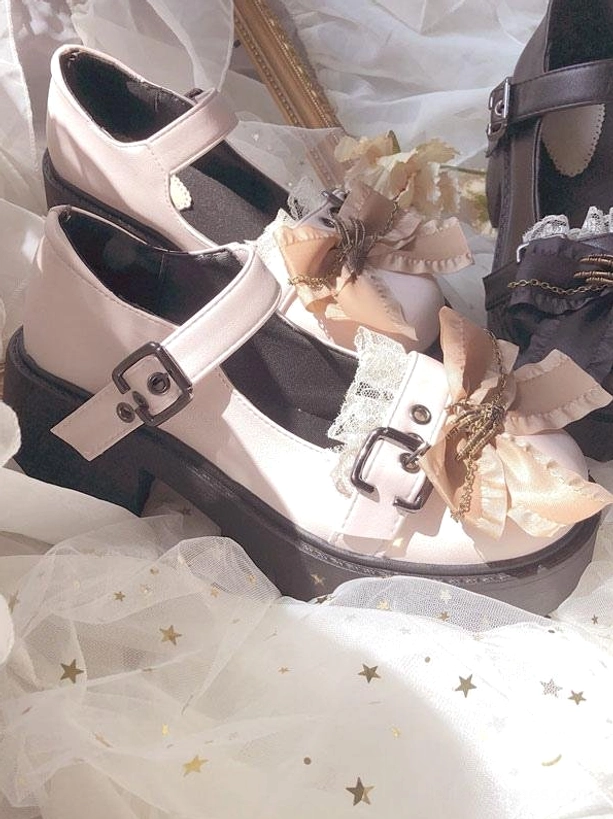 Beige Lolita platform shoes three-quarter side view with bow decor, lace trim, buckle ankle strap, and thick platform sole on star-patterned tulle background