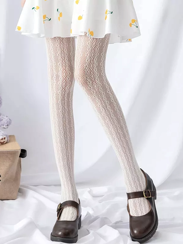 Beige vertical diamond mesh lolita tights front three-quarter standing view yellow cherry print skirt brown shoes