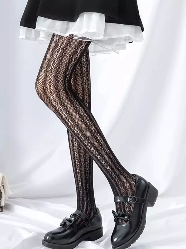 Beige diamond mesh lolita tights side lying view with plush rabbit prop and blue skirt detail