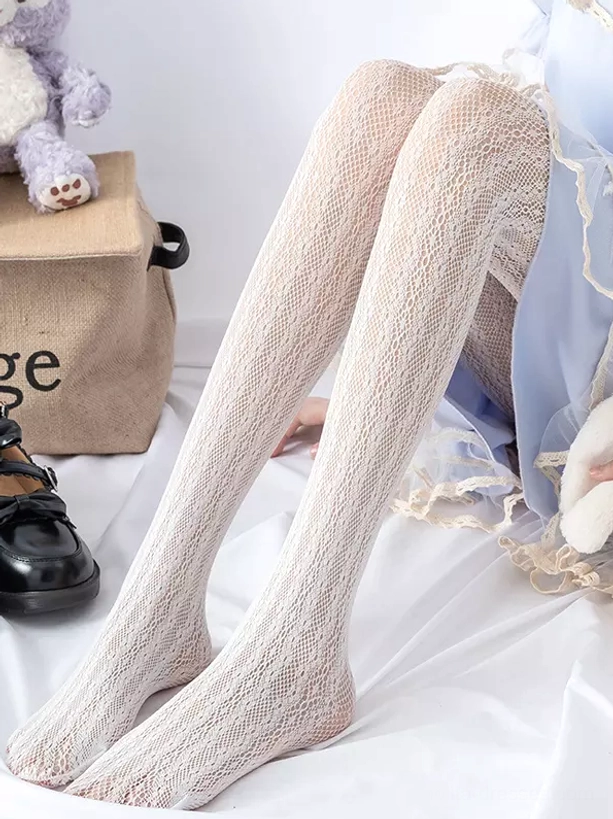 Beige textured lolita tights side low-angle reclined view with plush bear prop and blue skirt