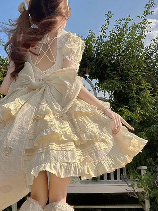 Beige sweet Lolita dress side rear view crisscross hollow back design large embroidered back bow ruffled short sleeves