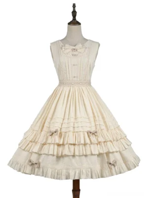 Beige sleeveless lolita jumper skirt dress displayed on dress form showing lace waistband neckline bow and layered ruffles with small bow decorations