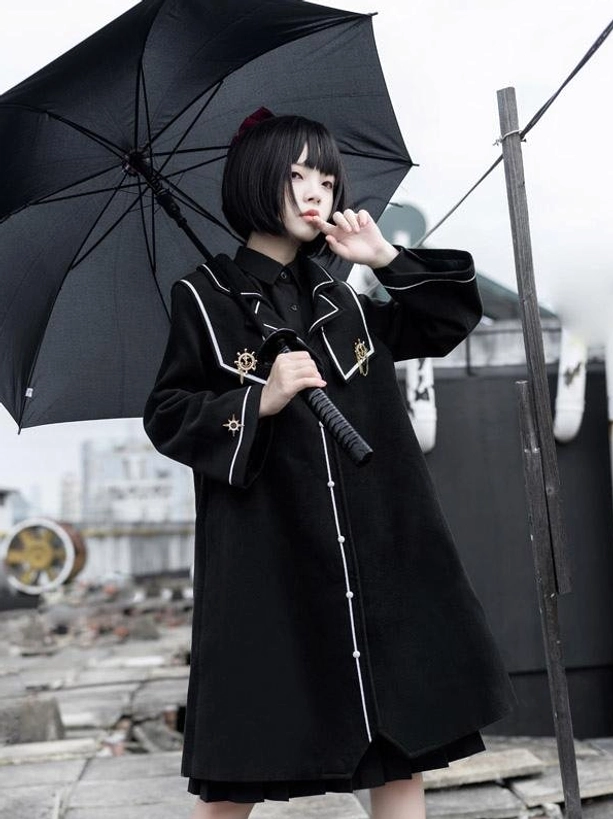 Black academic lolita overcoat three-quarter view on model with military trim details and white collar, long sleeve polyester coat perfect for lolita fashion tea parties