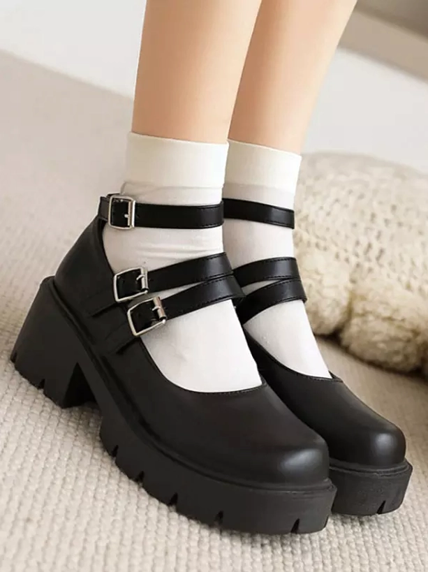 Black academic Mary Jane lolita platform pumps with dual buckle straps front side view on model wearing white crew socks