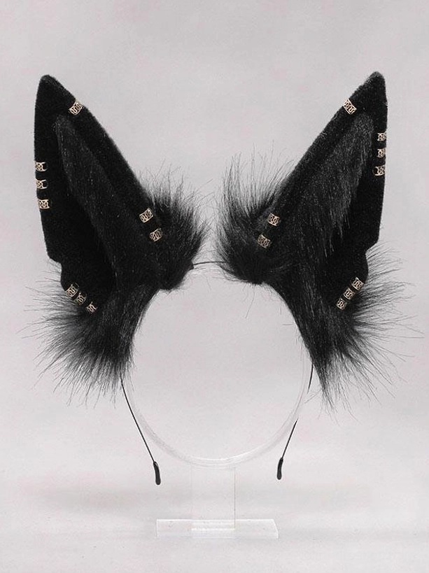 Black furry animal ear headband standalone product view on display stand, close-up showing solid black plush material and gold decorative studs detail for lolita accessories