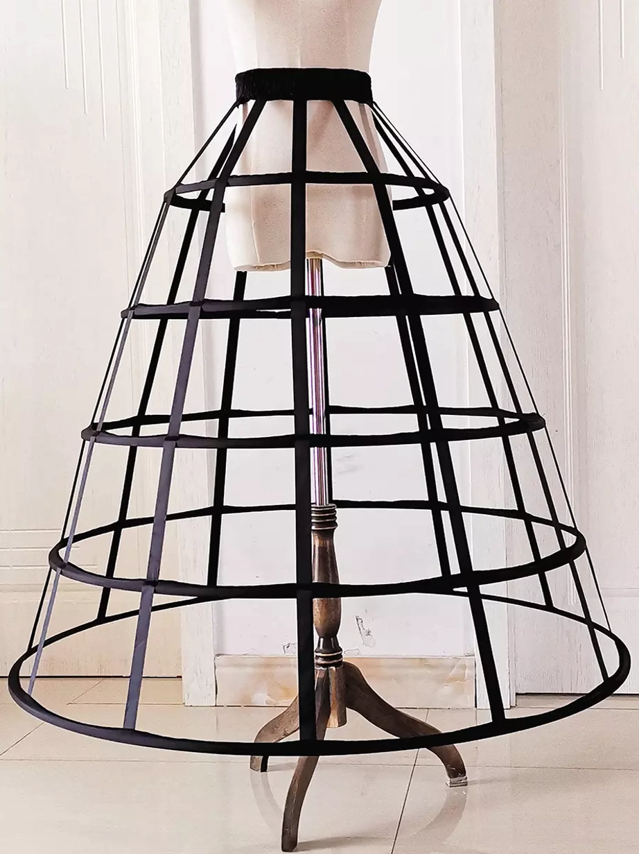 Black birdcage petticoat with steel hoops front full view showing A-line silhouette and hollow-out design on white background
