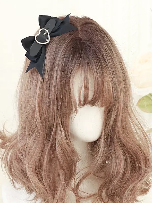 Single black bow hair clip with heart buckle detail side view on mannequin head sweet lolita hair accessory
