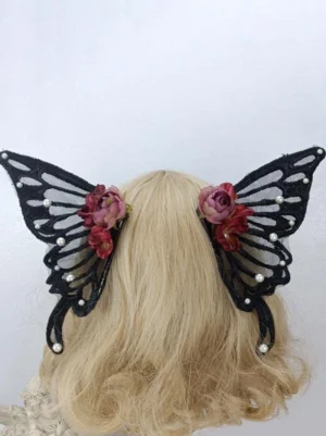 Black butterfly wing lolita headdress with sheer mesh wings and deep red roses with pearl accents worn on blonde curly wig mannequin back view