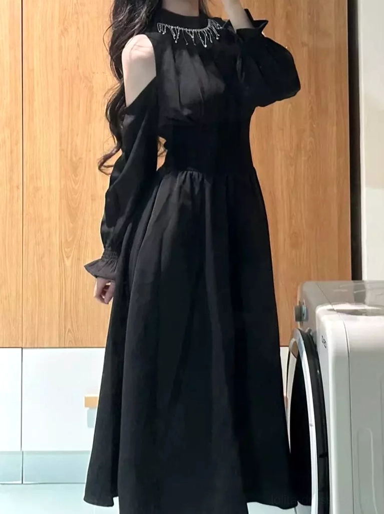 Side profile view of black lolita dress showing cinched waist, ruched details, and flowing maxi skirt silhouette with lantern sleeve cuffs