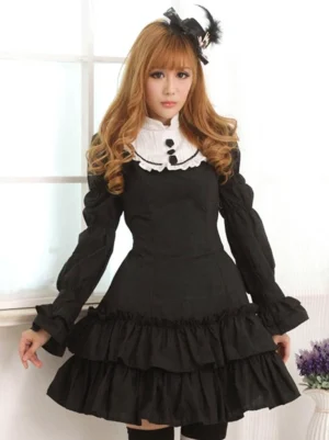 Black classic lolita dress with white peter pan collar and black decorative buttons front three-quarter view on blonde model wearing thigh-high stockings