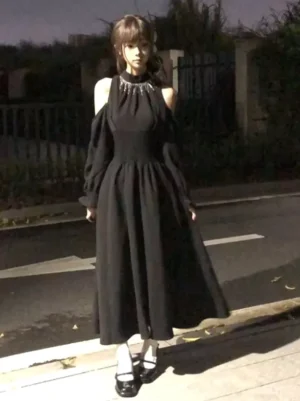 Black classic lolita halter maxi dress with rhinestone tassel neckline and cold shoulder design, full front view on model with long lantern sleeves
