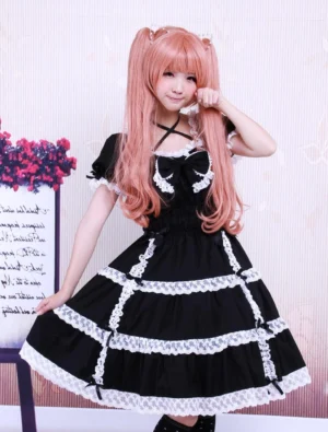 Black cotton Gothic Lolita dress with white lace trims and bow detail, three-quarter front view showing square neckline and short puff sleeves