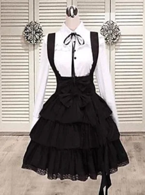 Black cotton classic lolita salopette jumper dress with integrated blouse front view mannequin display showing bow embellishment and tiered layered ruffle skirt hem gothic fashion