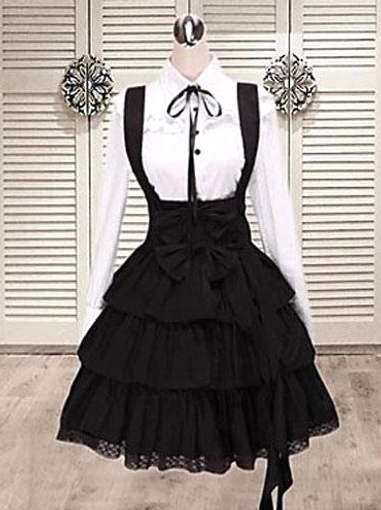 Black cotton classic lolita salopette jumper dress with integrated blouse front view mannequin display showing bow embellishment and tiered layered ruffle skirt hem gothic fashion