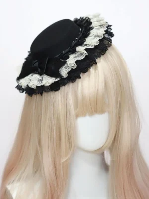 Black crown Classic Lolita headdress with multi-layer ruffled lace and black satin bow embellishment, front three-quarter angle display on mannequin