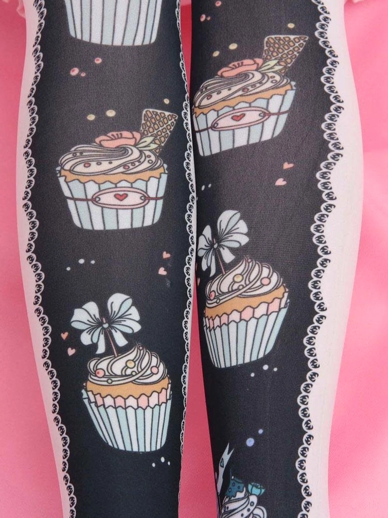 Close-up detail of black Lolita socks showing pink lace side trim cupcake prints and tiny heart dot decorations