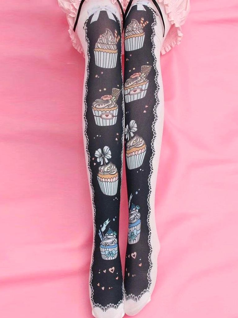 Black velvet printed Lolita thigh high socks with cupcake design and lace trim worn with pink skirt overhead view